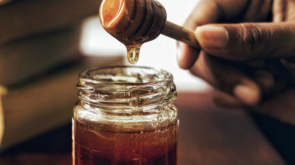 Jar of Mercy Gold honey with honeycomb